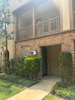 the front door of an apartment building with a porch